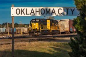 Oklahoma sign with train in background