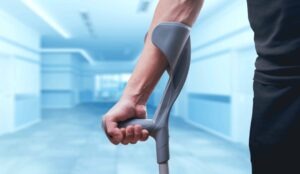 A man walks on crutches. A Phoenix truck accident lawyer can maximize your compensation and protect your rights against big trucking companies.