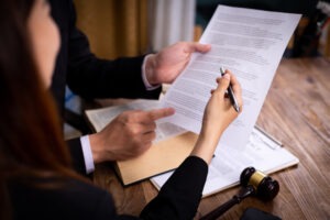 client and lawyer reviewing retainer agreement